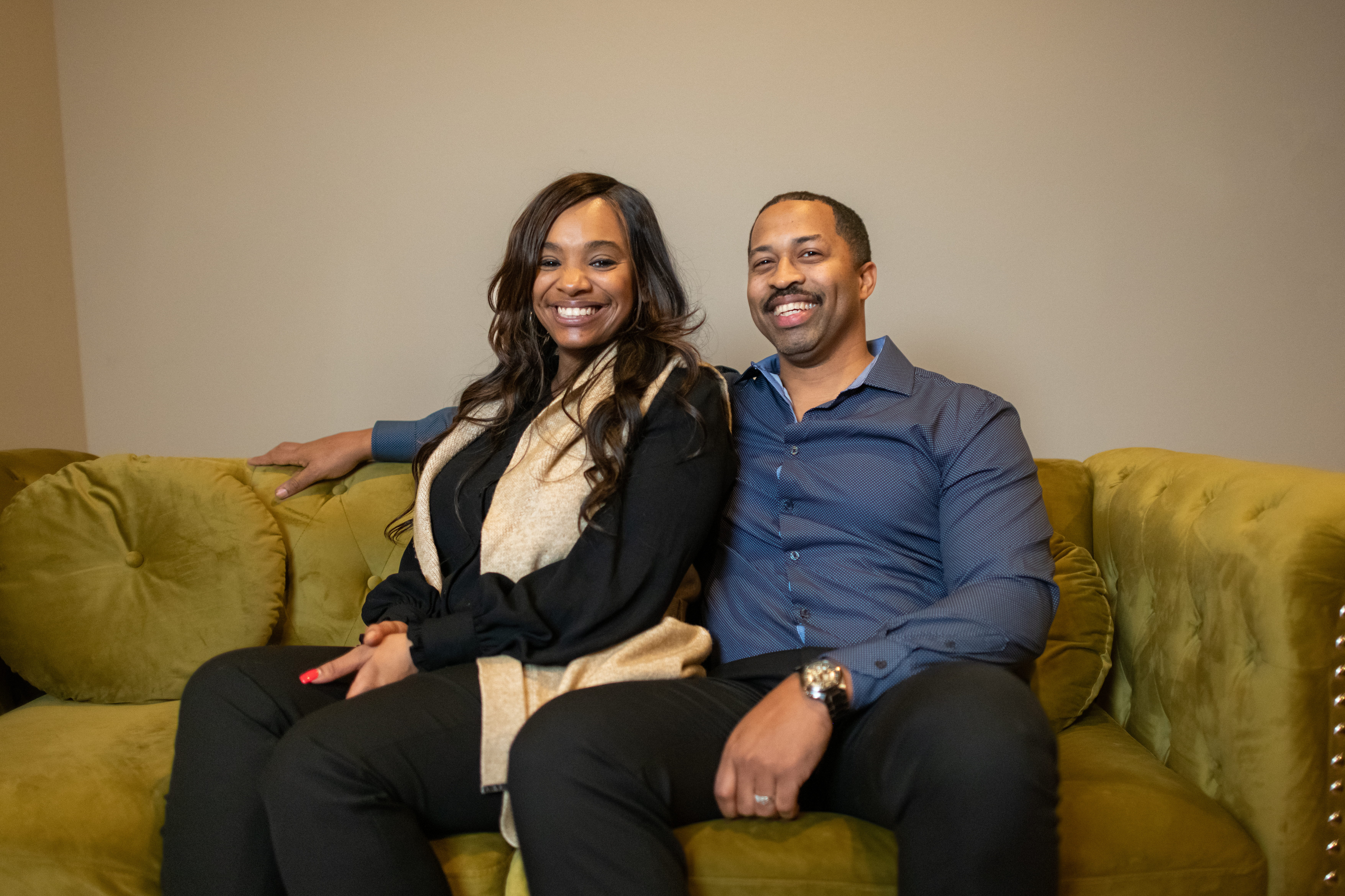 Woman and man sitting next to each other on a couch 