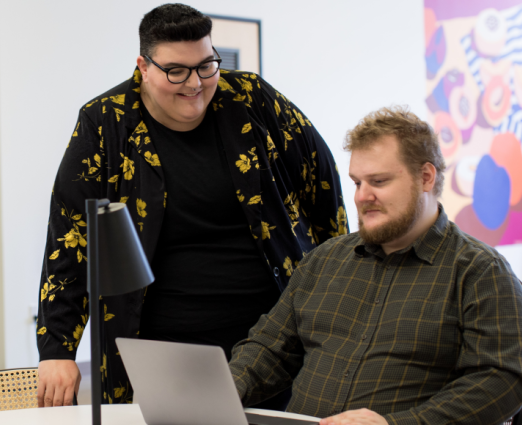 Two people looking at a laptop together